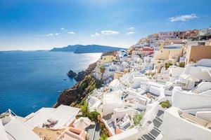 Amazing panoramic landscape, luxury travel vacation. Oia town on Santorini island, Greece. Traditional and famous houses and churches with blue domes over the Caldera, Aegean sea photo