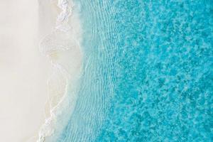 Beach and waves from top view. Turquoise water background from top view. Summer seascape from air. Top view from drone. Travel concept and idea photo