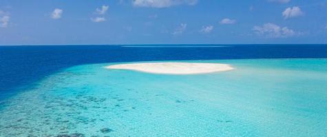 Maldivian sandbank in Indian ocean, white sandy coast with crystal azure color water, perfect getaway for tropical vacations photo