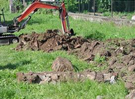 Excavator digging a hole photo