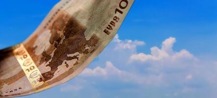 10 Euro bills against blue sky background photo