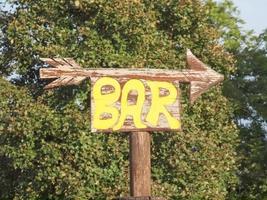 Bar sign with direction arrow photo