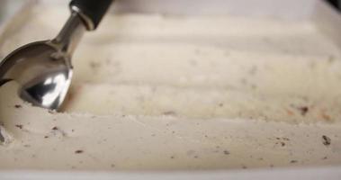 Close up, Vanilla chocolate chip ice cream scooped with a spoon. The texture of the ice cream is rolled into a ball. video