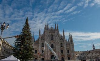 Milan Italy 2021 Workers on the platform decorating the Christmas tree photo