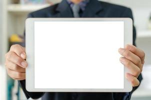 Businessman holding a blank white touch screen tablet. Used to put text or information to advertise news or sell products online. concept marketing business photo