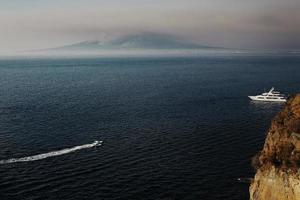 boat in the sea, mountain on the background of the sea. Sorrento, view over Neapolitan Bay photo