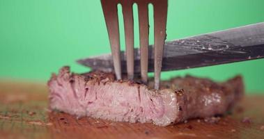 Close up, Chef uses a knife to cut medium rare staek. Staek one piece of medium rare. video