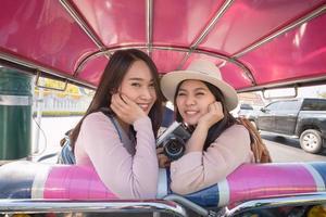 Beautiful asian tourists woman enjoy travel together in urban city downtown on vacation photo