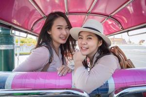 Beautiful asian tourists woman enjoy travel together in urban city downtown on vacation photo