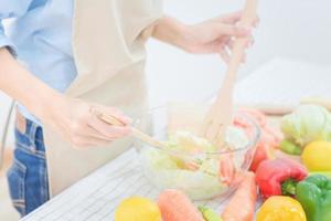Young asian woman prepare healthy food salad at home. Elegant design for Healthy lifestyle,diet and happiness concept photo