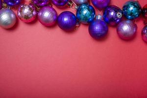 Christmas composition. Christmas red decorations, Christmas tree toys on a red background. photo