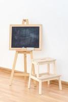 Wooden blank blackboard inside the room for kids playing and education teaching by parent for modern happy family activity. photo