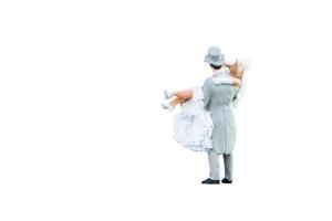 Close up of Miniature people wedding bride and groom couple isolated with clipping path on white background.Elegant Design with copy space for placement your text, mock up for love and wedding concept photo