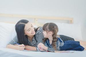 Funny mom and lovely child having fun together.Photo design for family, children and happy people concept photo