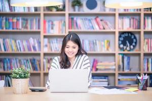 Asian business freelancer smiling while chat with her marketing team at Co Working Space office.Conceptual for startup small businesses entrepreneur and freelance. photo
