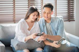 Asian couple lovers enjoy and play console game on vacation make more quality time of happiness together at home photo