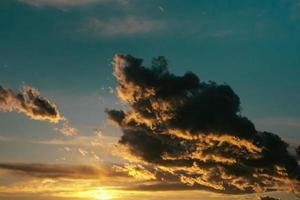 sunset through a big cloud photo