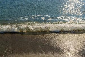 waves of the sea on the sand photo