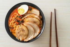 Ramen Noodles Spicy Tomyum Soup with Roast Pork photo