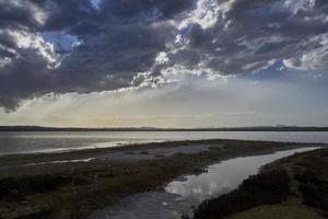 Sunset on the pink lagoon of the salt flats of Torrevieja, Spain photo