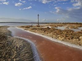 Sunset on the pink lagoon of the salt flats of Torrevieja, Spain