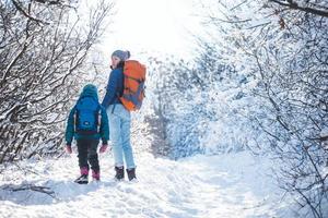 Woman with a child on a winter hike in the mountains.