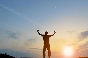 A silhouette of a man dreaming of gaining muscle. photo