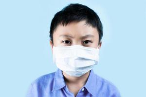Little boy wearing healthy masks for protect virus photo