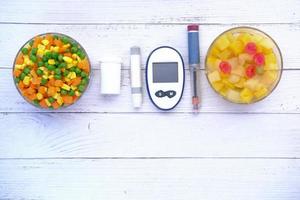 diabetic measurement tools and healthy food on table photo