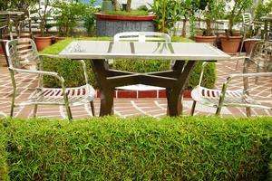 many empty chair at cafe in a park photo