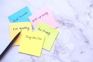 new year goals on a sticky note on table , photo