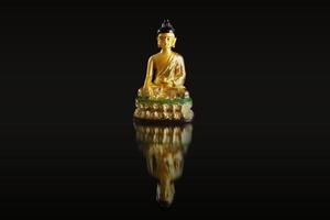 Budhha against a black backdrop with reflection. photo