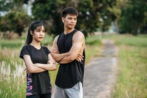 Men and women standing and cross arms exercise after. photo