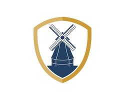 Simple shield with windmill in the farm field vector