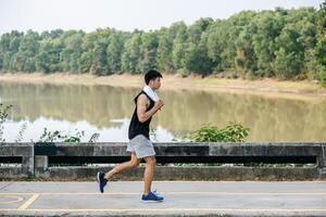 Men exercise by running on the road on the bridge. photo