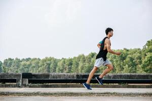 Men exercise by running on the road on the bridge. photo