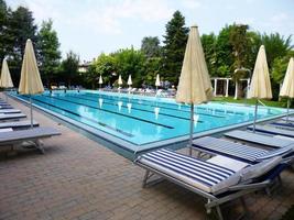 Abano, Italy, 2015 - Sun beds near the thermal swimming pool of a luxury spa and wellness center. Italy