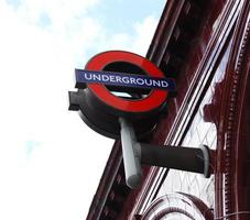 London, United Kingdom, 2014 - Subway sign hanging from a building of London. London Underground sign photo