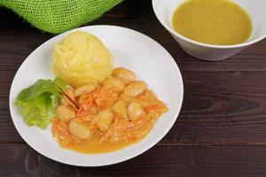 Beans with carrots and potatoes on a table photo