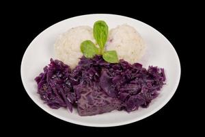 Tempeh with red cabbage and sorghum on a black photo