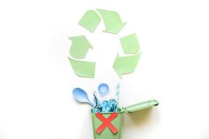 recycle symbol bin with plastic rubbish