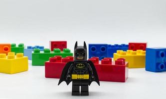 Bologna, Italy, 2021 - Lego Batman miniature against Lego building blocks isolated on white background. photo