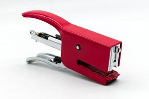 Red metal stapler isolated on white background photo