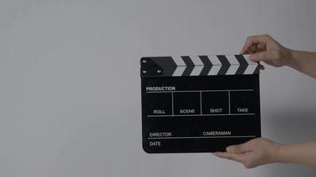 Clapper board. Close up hand and film making clapperboard isolated on background video