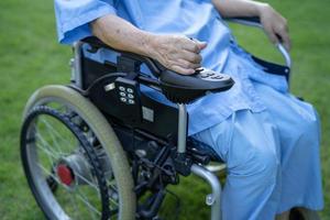 Asian senior or elderly old lady woman patient on electric wheelchair with remote control at nursing hospital ward, healthy strong medical concept photo