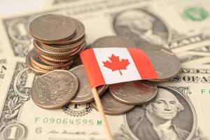 Stack of coins with Canada flag on dollar banknotes. photo