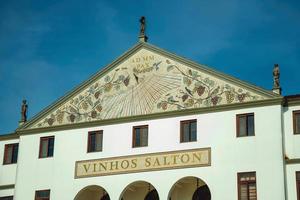 Bento Goncalves, Brazil - July 10, 2019. Painted pediment and company signboard on the facade of Salton Winery building near Bento Goncalves. A friendly country town famous for its wine production. photo