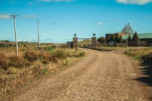 Cambara do Sul, Brazil - July 16, 2019. Dirt road coming from the gate of a farmstead in the lowlands called Pampas near Cambara do Sul. A small country town with amazing natural tourist attractions. photo