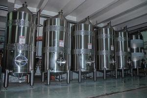 Bento Goncalves, Brazil - July 11, 2019. Stainless steel storage tanks and equipment for wine production at Aurora Winery in Bento Goncalves. A friendly country town famous for its wine production. photo