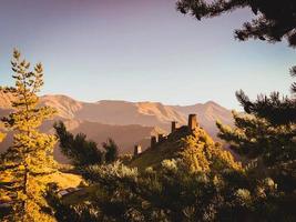 Keselo hill with traditional tushetian towers and tranquil landscape. Travel Tusheti national park historical landmarks photo